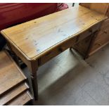 A 20th century pine side table with a rectangular top above two drawers on turned legs