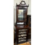 An Edwardian mahogany chiffonier with a carved cornice above a bevelled glazed door,