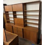 A mid 20th century teak G-Plan three section wall unit with cupboards,