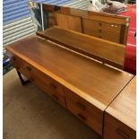 A mid-20th century teak dressing table, with a rectangular mirror and six drawers on shaped legs,