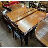 An Edwardian mahogany extending dining table on carved legs together with a set of four chairs