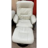 A cream leatherette reclining elbow chair and footstool
