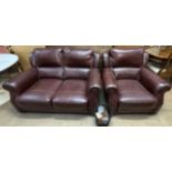 A brown leather two seater settee together with a matching armchair