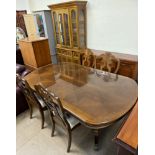 A reproduction extending dining table and four chairs together with a modern wall unit and a