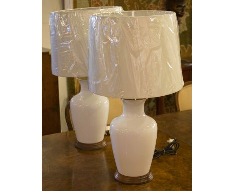 LAMPS, a pair, vase shaped ceramic white each with turned wooden bases and shades, 66cm H. (2)