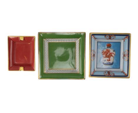 Three ashtrays, to include: [a] A small red Limoges ashtray with gilded edges [b] A 'Dragon' A Raynaud &amp; Co. Limoges asht