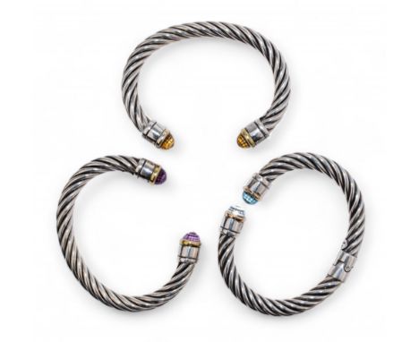 Contemporary A group of three silver twist gold and gem set bangles. The terminals set with topaz, citrine and amethyst.