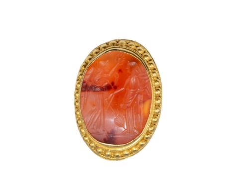 Ancient (?) A carnelian intaglio with two figures mounted in a heavy 18k gold beadwork and wire twist mount as a ring. Finger