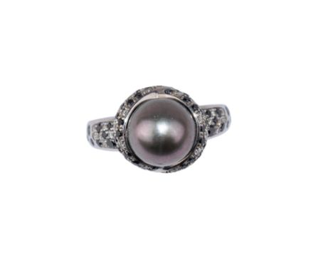 Mauboussin Paris Circa 1980 A black pearl (untested), diamond and black diamond cluster ring Mounted in 18 carat whit gold Si