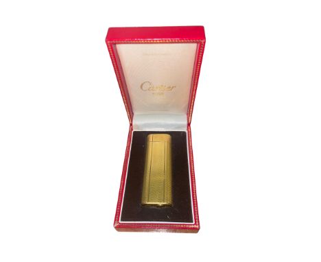 Cartier, Paris A gold plated gas lighter. Wave design, of vertical type Numbered 75125D With original box, additional flints 