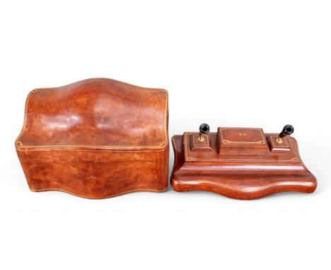 Asprey of London A leather desk set, including a pen stand, a blotter, a note pad and a correspondence box. Tanned leather wi