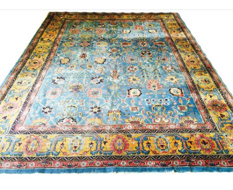 ANTIQUE TABRIZ CARPET, 370cm x 277cm, all over palmette and scrolling vine design on a powder blue field within multiple corr