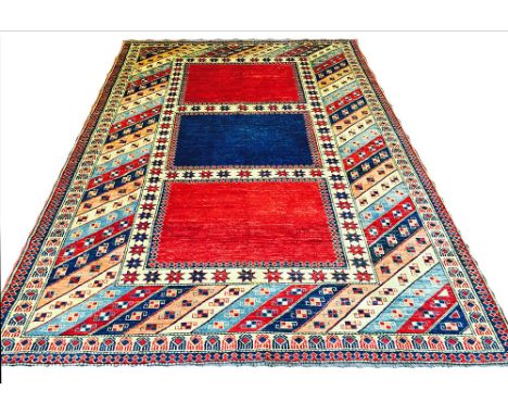 VERY FINE UNUSUAL KAZAK CARPET, 308cm x 207cm, triple star bordered fields within multiple geometric polychrome borders.