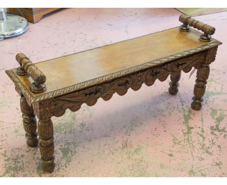 HALL BENCH, Victorian Gothic oak with turned bolster handles and carved frieze supports, 106cm x 29cm D x 50cm H.