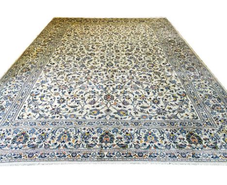 FINE SIGNED KASHAN CARPET, 428cm x 304cm, ivory field of palmettes and scrolling vines within complimentary borders.