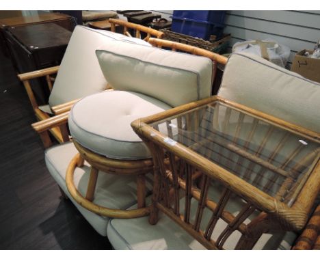 A modern canework conservatory suite including pouffe and table 