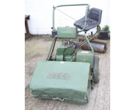 An Atco rotary ride on petrol lawn mower with grass collector. L120cm (excluding chair)