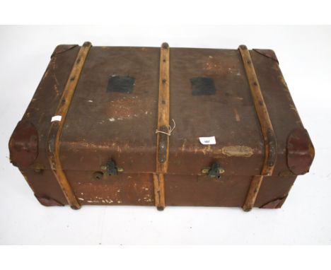 A vintage banded steamer trunk. Made by H B Brand, with a striped cotton interior, wooden banding and reinforced leather corn