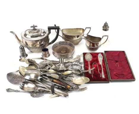 An assortment of silver plate. Including a Victorian half ribbed three piece tea service, flatware, etc.