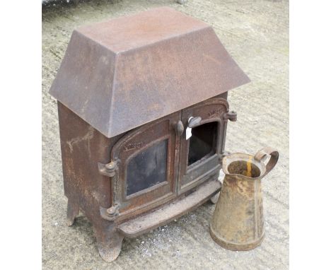 A vintage Villager wood burner and a metal jug. Woodburner H73.5cm x W58cm x D40cm 