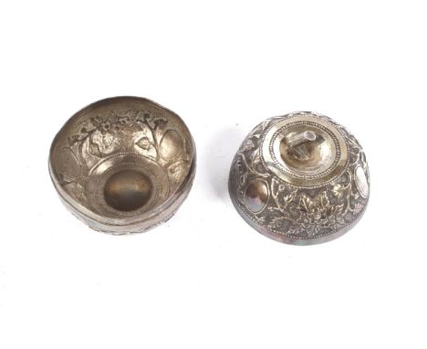A Chinese white metal lidded box/tea caddy of apple form. Profusely embossed with tree peonies and flowers, Diameter 8.2cm