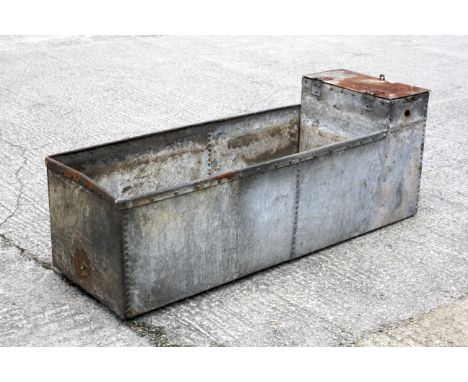A galvanised metal riveted water trough. 6ft in length not watertight but would make excellent planter.
