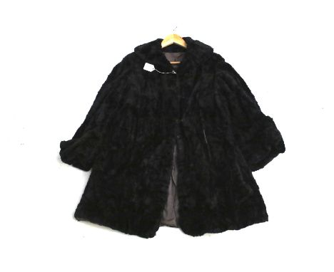 A vintage womens black mole overcoat. Lined in grey fabric, L87cm