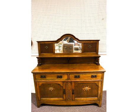 A vintage oak sideboard. Consisting of two long drawers with cast metal handles, over a pair of panelled doors, the left one 