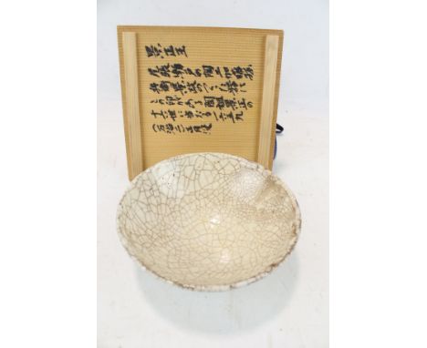 A Chinese part beige glazed studio bowl with dark craquelure. Mark to base. In original inscribed box. H6.4cm x diameter 16cm