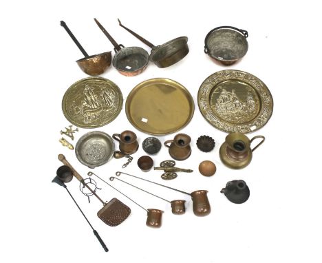 An assortment of copper and brassware. Including pans, trays and a candlestick, etc. H20cm