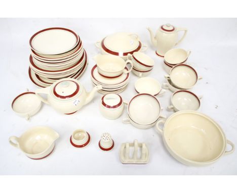 A mid-century tea service. Glazed in cream with blue and red rims, including teapots, coffee pots, plates, cups and saucers, 