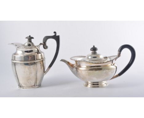 George IV style silver teapot, Sheffield 1919, compressed form with a bobbin moulded outline, ebonised handle and finial, 13c