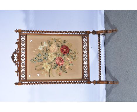 Victorian walnut framed firescreen, carved and fretted, woolwork panel, 118cm.