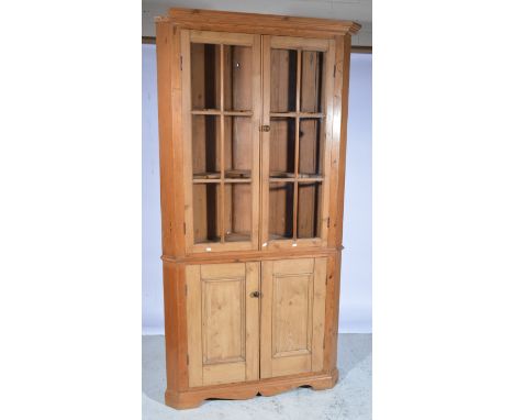 Victorian pine corner cupboard, moulded cornice, upper glazed doors enclosing shelves, cupboard below bracket feet,  W115cm x