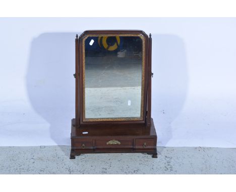 An Edwardian mahogany rectangular swing toilet mirror, the rectangular base having three concave drawers all supported on cor