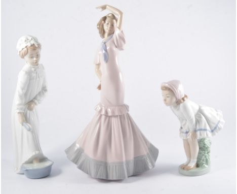 Lladro  model, two nuns, No.4611, 33cm, chipped hat; and seven Nao porcelain figures of girls.