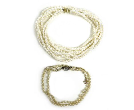 Two pearl necklaces, one a 19th century example with yellow metal clasp inset with grey seed pearls, drum form peach coloured