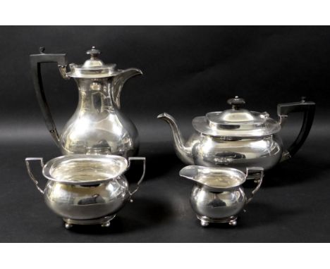 A silver composite four piece tea service, each of baluster form raised on four ball feet, comprising coffee pot, 24cm high, 