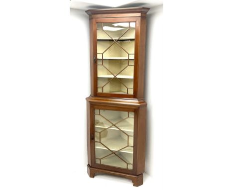 Early/mid century mahogany corner display cabinet, projecting cornice above two astragal glazed doors, enclosing lined interi