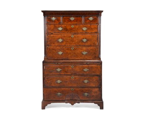 A George II burr walnut and feather banded chest on chest, circa 1735, the moulded cornice above three short and three long g