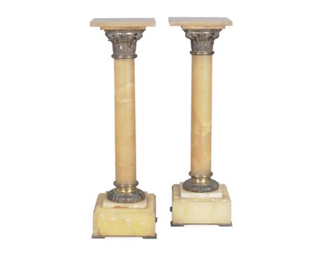 A pair of French onyx and gilt metal mounted pedestals, early 20th century, each with square top above a Corinthian capital a