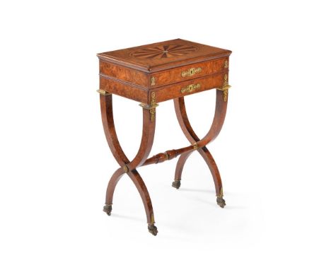 A Charles X amboyna, satinwood and specimen wood and parquetry work table, circa 1830, the hinged rectangular top with centra