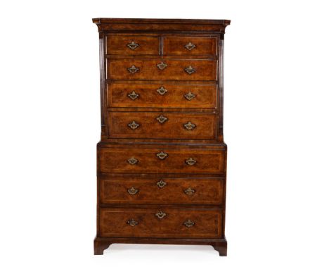 A George II walnut chest on chest, circa 1735, the moulded cornice above two short and three long graduated drawers, the lowe