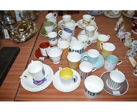 A quantity of Susie Cooper designed tea and coffee cups, some with saucers.