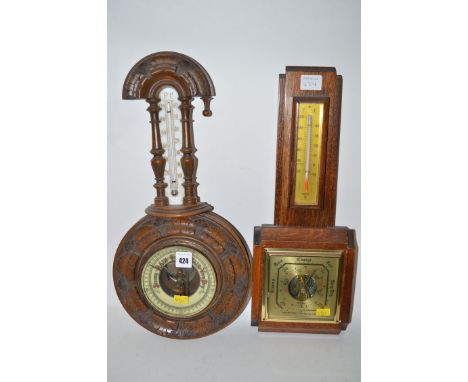 A Victorian aneroid barometer and a thermometer, in ornate banjo shaped carved walnut case; together with a modern barometer 
