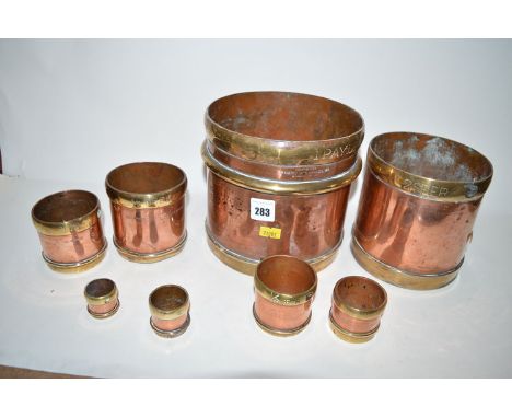 "The Oriental Metal Pressing Works", a set of graduating brass and copper measuring cups, Bombay. (8)