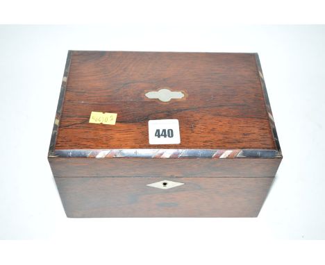 A small 19th Century rectangular rosewood tea caddy, the hinge cover opening to reveal two lead lined compartments (missing o