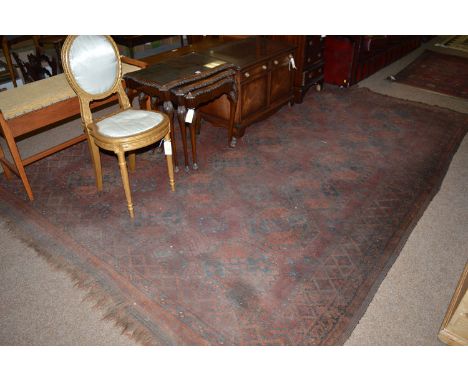 An early 20th Century Turkoman style carpet, with tekke medallions, 87 x 116in.
