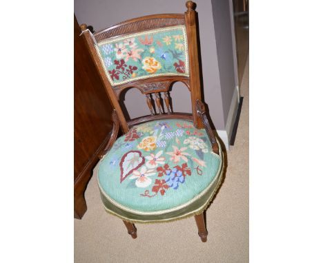 A Victorian walnut occasional chair, the bowed cresting rail with reeded frieze above tapestry upholstered back and seat, rai