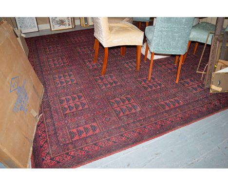 A modern machine made carpet decorated with foliate panels.